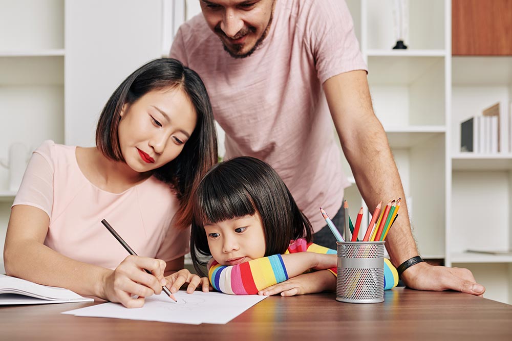 SIS parents teaching daughter GUMX5Q7